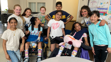 28June2023 - Superintendent Newsletter - McMillan Group of diverse learners gathered together for a photo with smiling faces