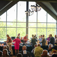 Attendees plating food at the buffet tables